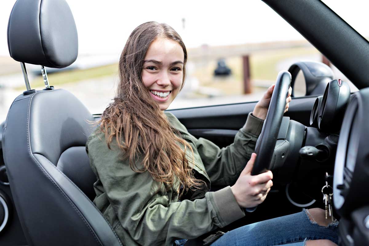 Young girl driving car