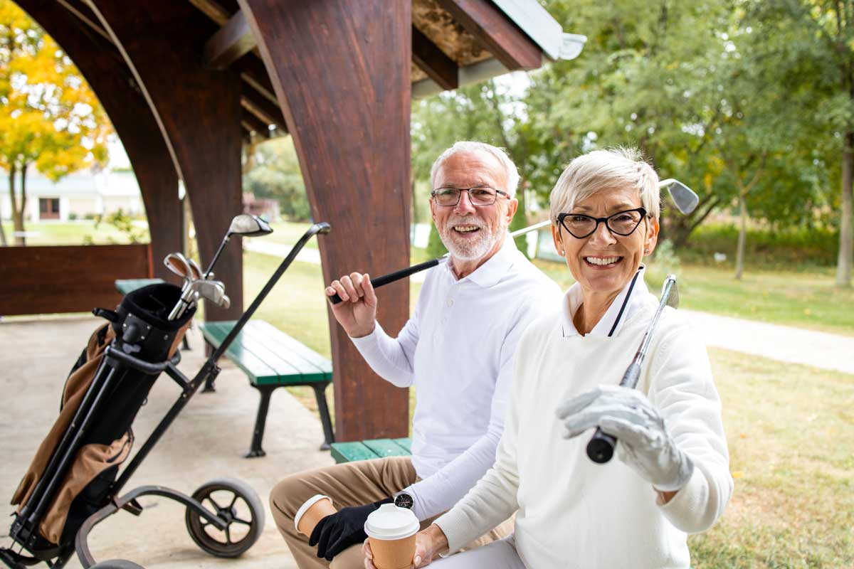 retired couple playing golf