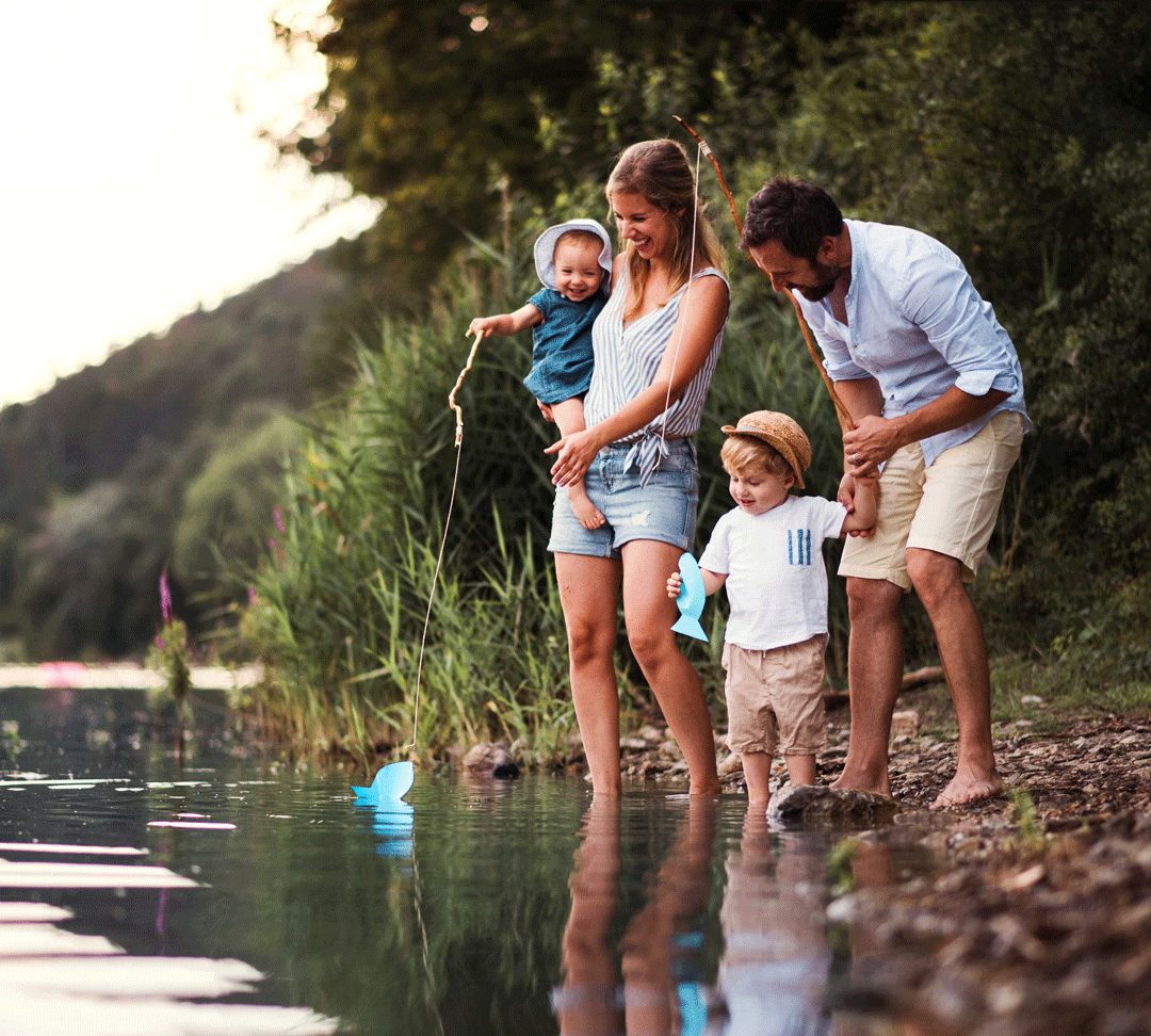 Couple with two young children play fishing