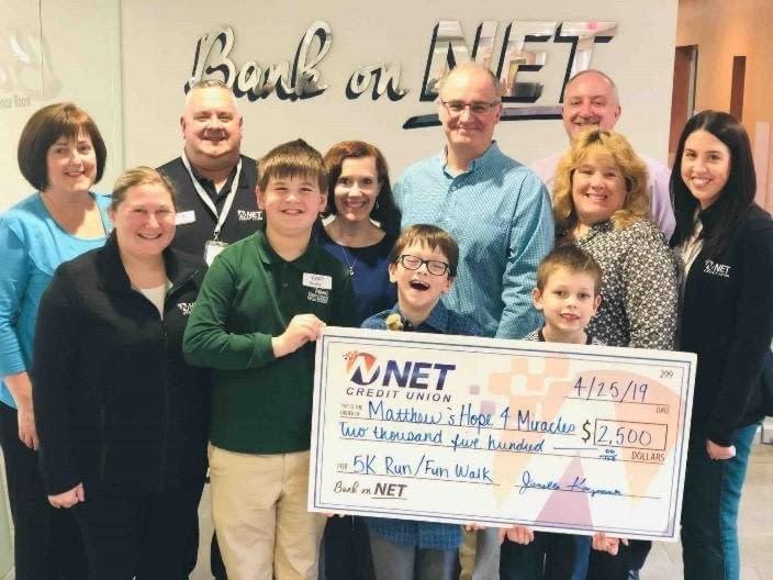 NET presenting a donation check to Matthew's Hope for Miracles